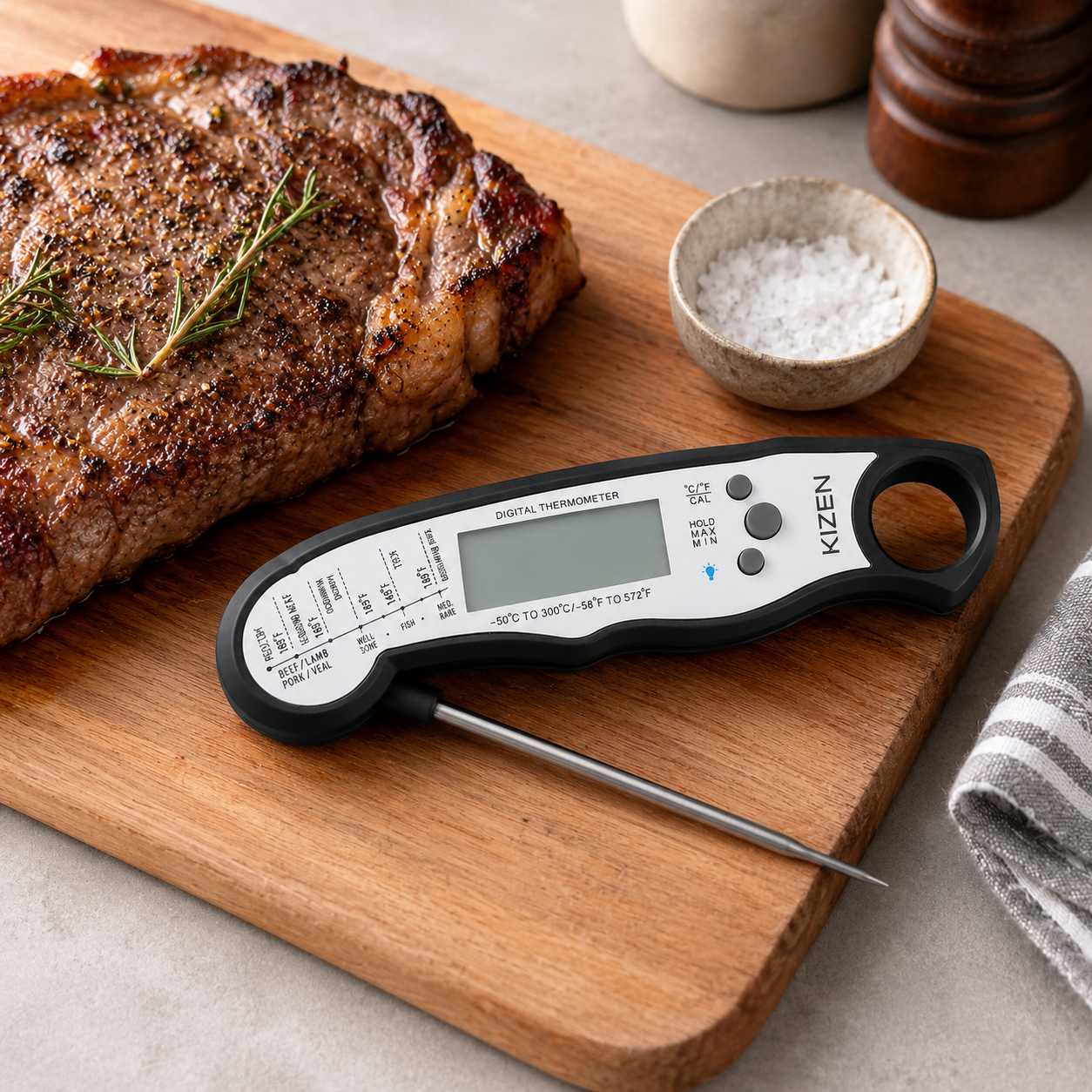 KIZEN digital meat thermometer beside steak on a cutting board