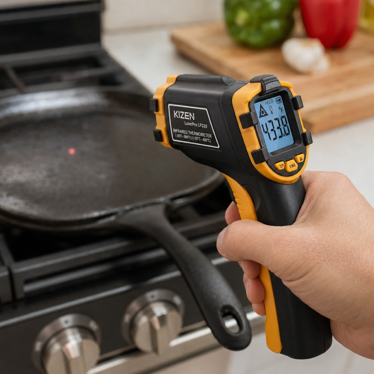 KIZEN infrared thermometer gun pointed at a pan